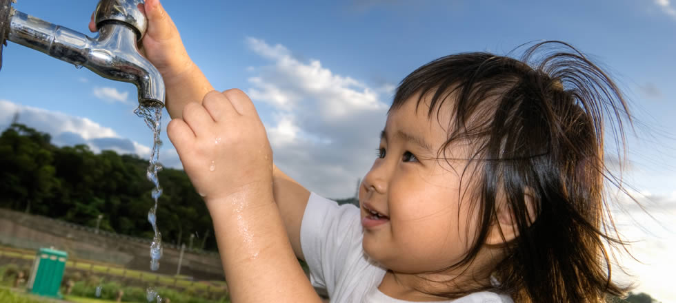 Girl opening water tap