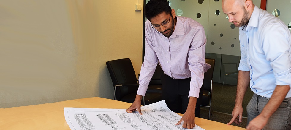 Two employees looking at drawing