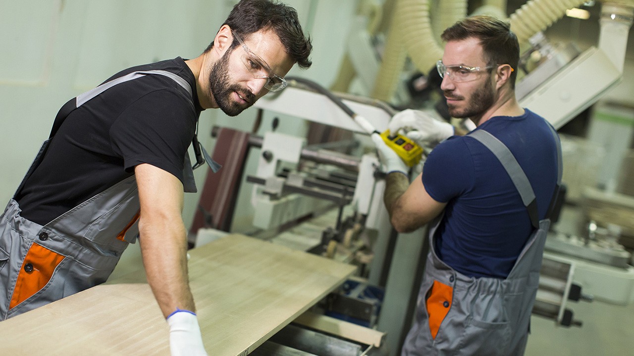 Two employees working with wood